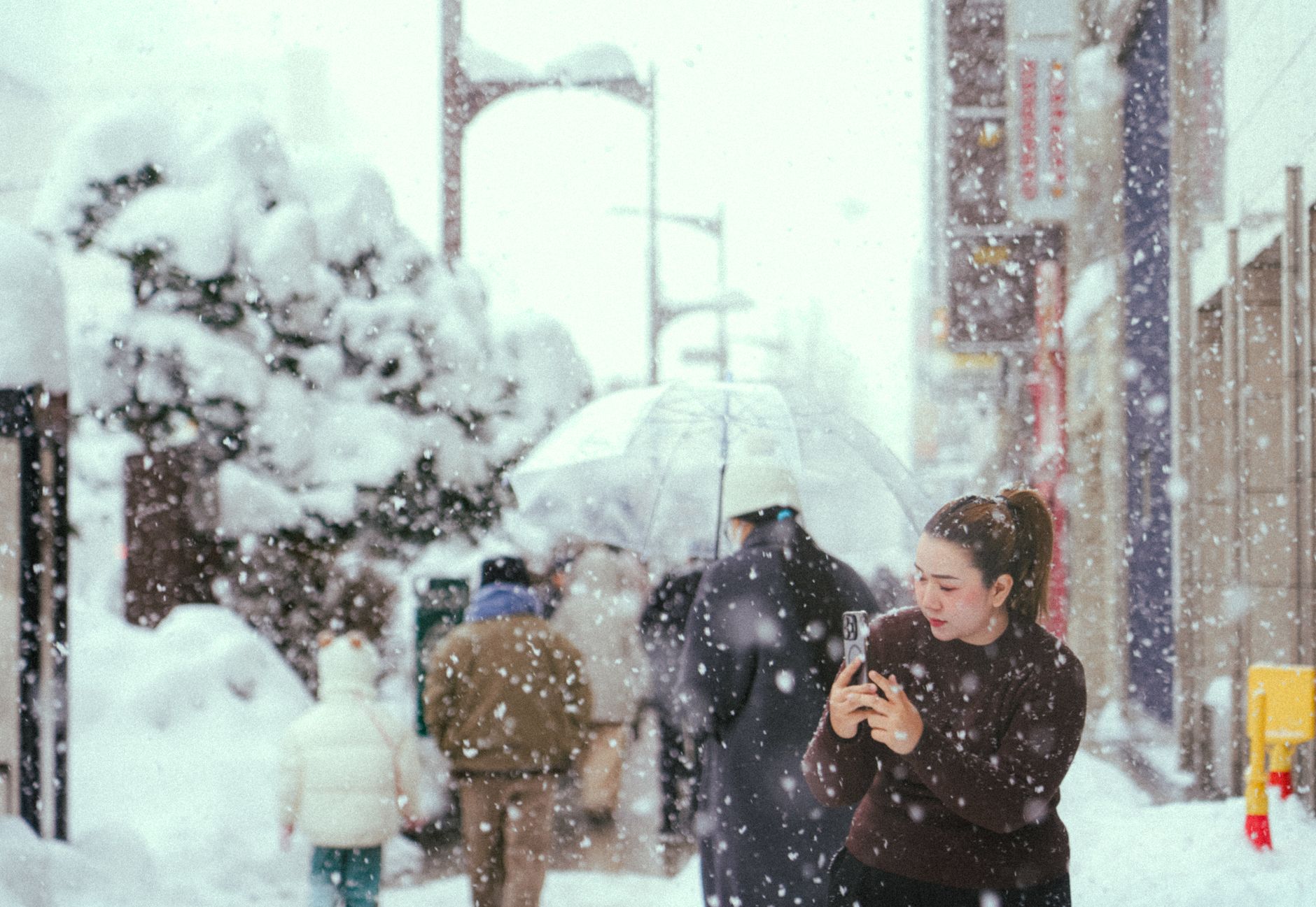 winter street scene with falling snow in japan