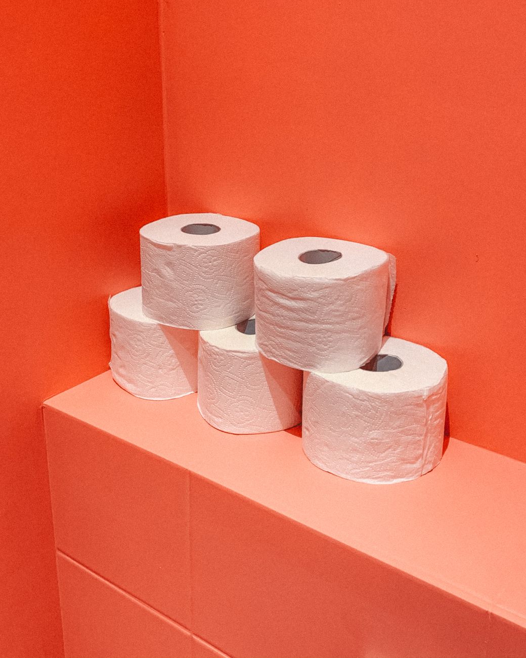 white tissue paper roll on pink table